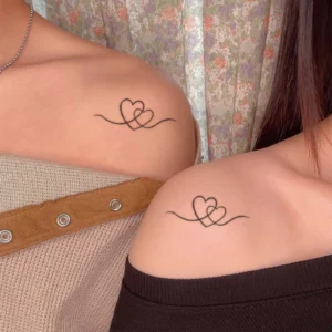 Celebrate Eternal Connection with This Interlocking Hearts Heart Tattoo
