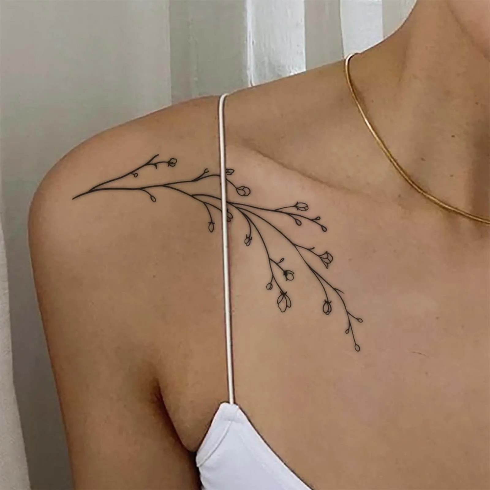 Celebrate Growth with This Delicate Branch & Bud Boho Tattoo