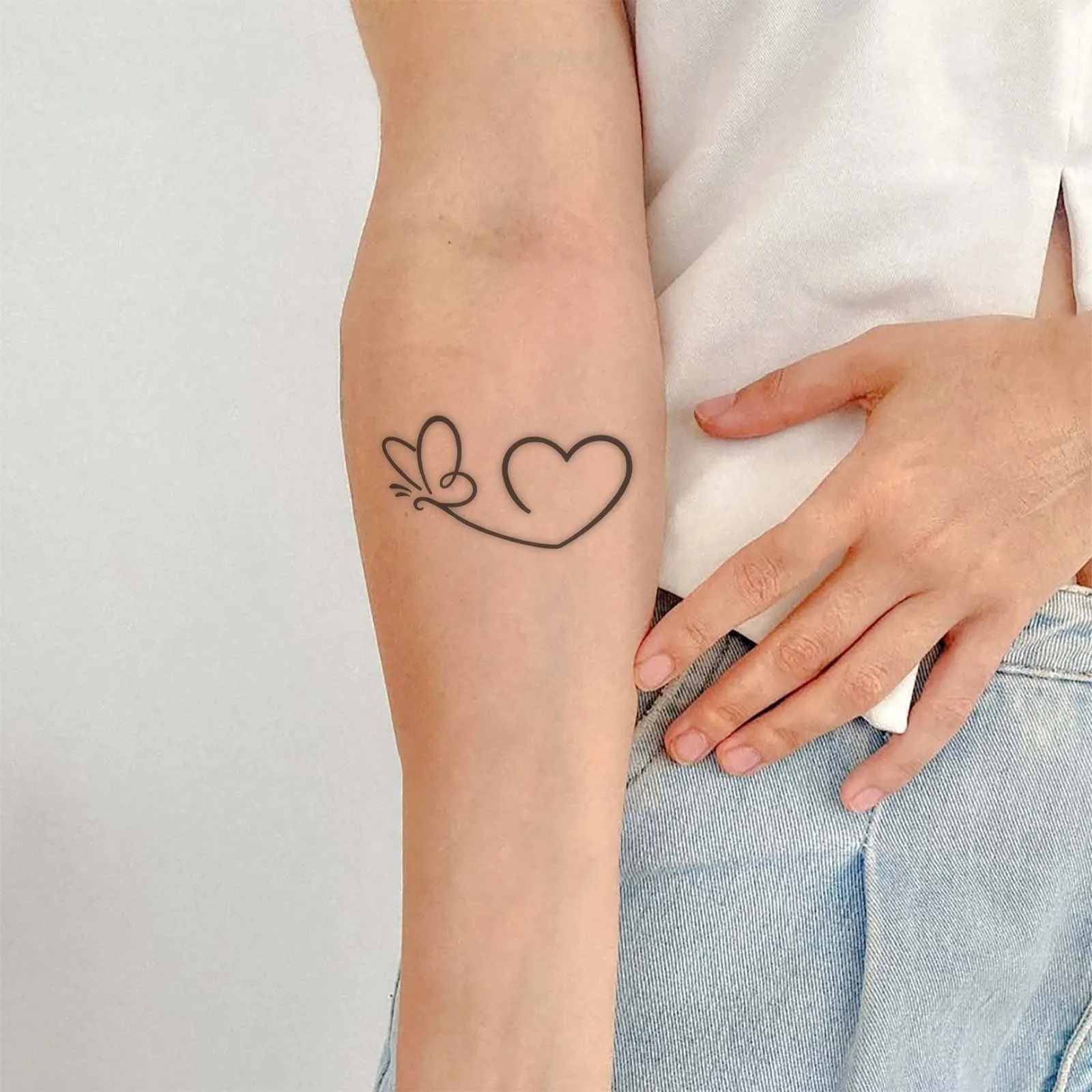 Wear Symbolic Love with This Butterfly & Heart Outline Heart Tattoo