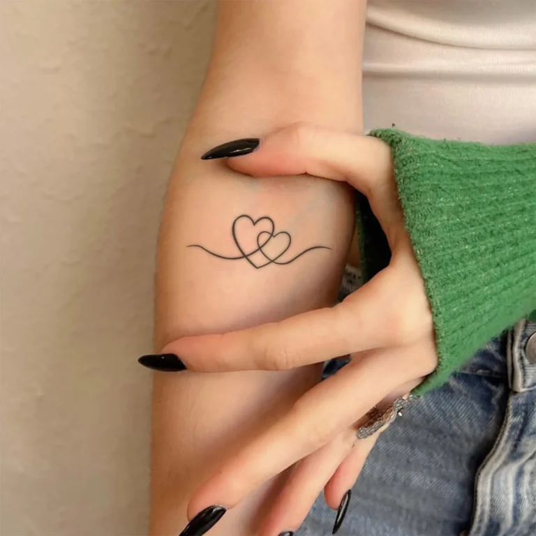 Celebrate Eternal Connection with This Interlocking Hearts Heart Tattoo