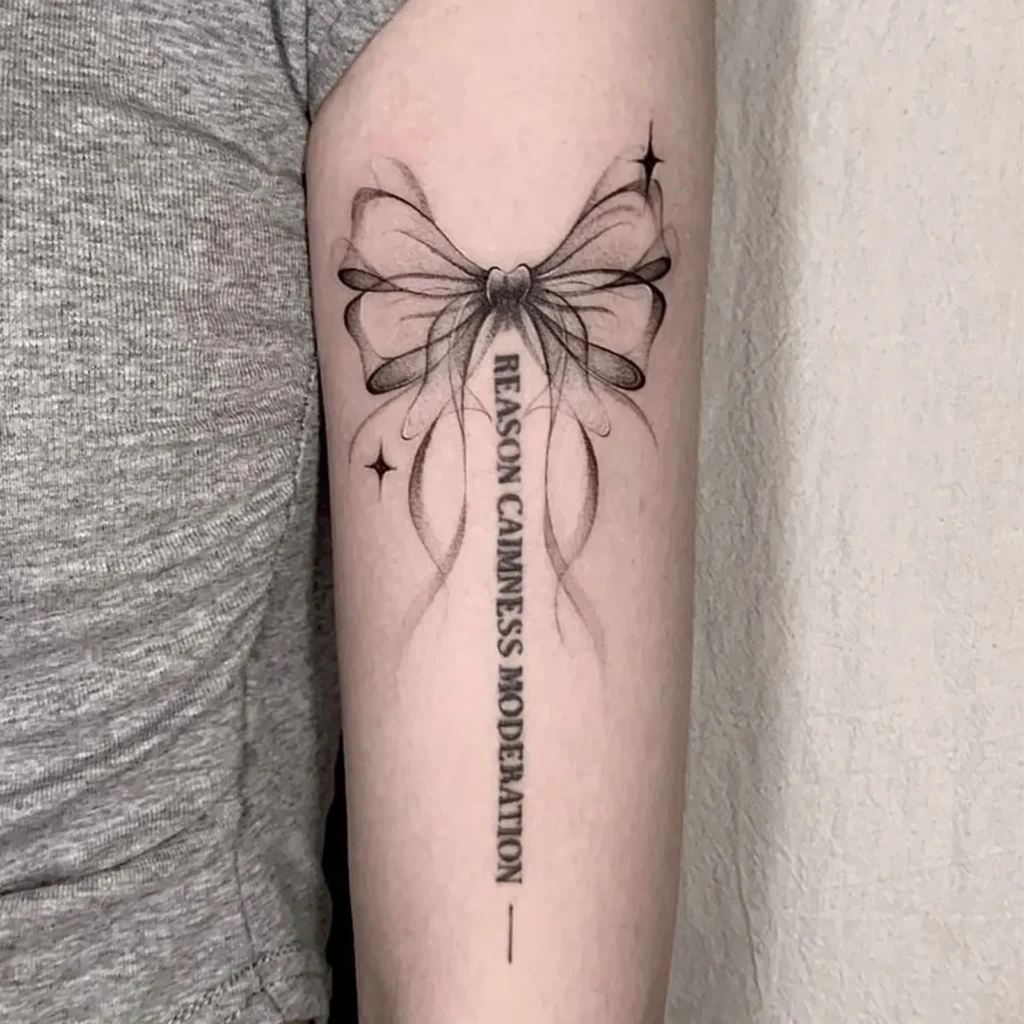 One of the most popular tattoos for Y2K lovers. Ribbon bow with cute script.