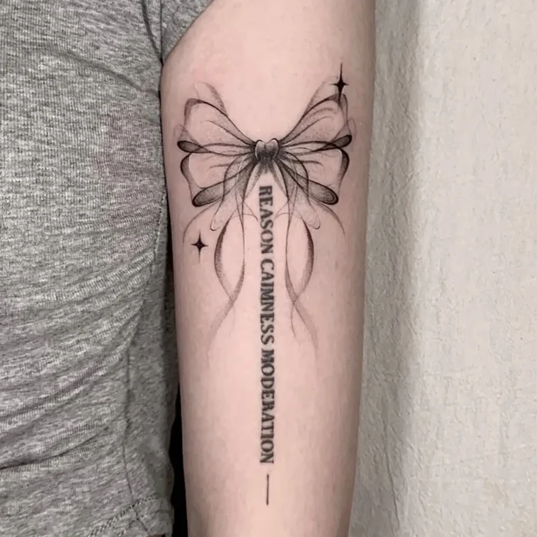 One of the most popular tattoos for Y2K lovers. Ribbon bow with cute script.