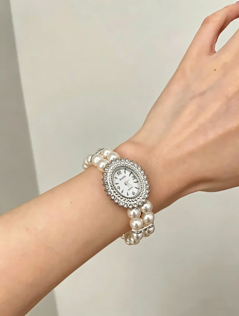 A vintage pearl bracelet watch with bohemian charm. Stretchy elastic band, faux pearls, and retro style.