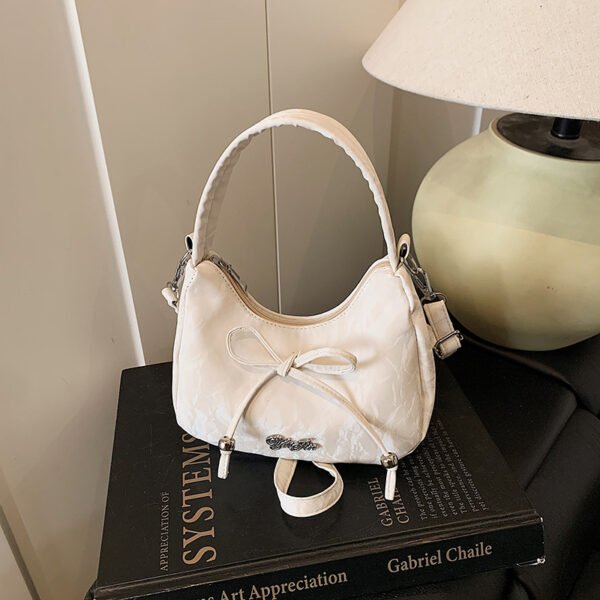Bow shaped crossbody bag in structured bow silhouette. Cute mini PU leather purse. Fits phone and essentials.