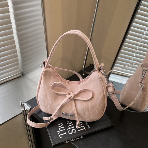Bow shaped crossbody bag in structured bow silhouette. Cute mini PU leather purse. Fits phone and essentials.
