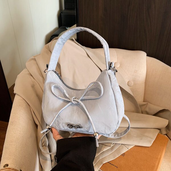 Bow shaped crossbody bag in structured bow silhouette. Cute mini PU leather purse. Fits phone and essentials.