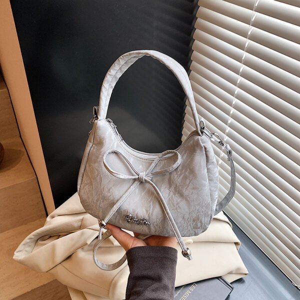 Bow shaped crossbody bag in structured bow silhouette. Cute mini PU leather purse. Fits phone and essentials.