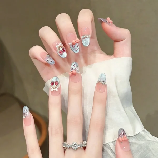 Cherry press on nails with hand painted bow design. Medium length, cute girly false nails for daily wear. 3D cherries and glossy finish.