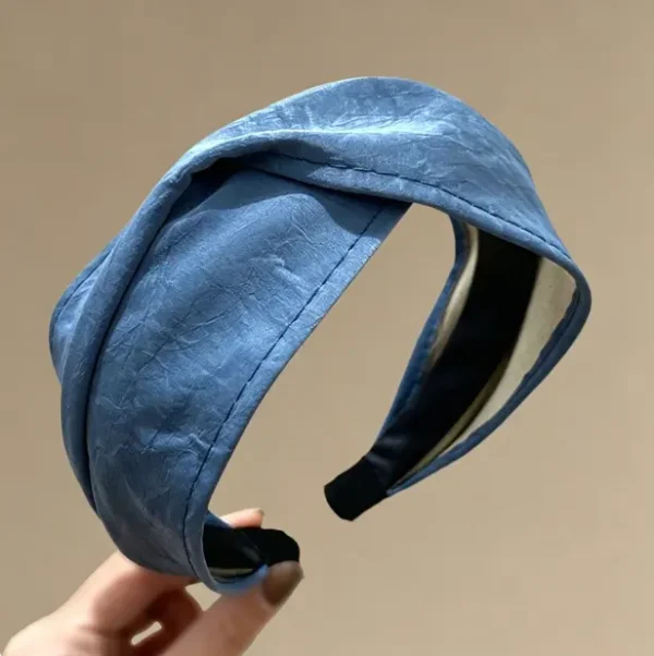 Cross front headband in vintage blue. Twisted leather hair band with high crown lift. One size fits most. Perfect for retro looks.