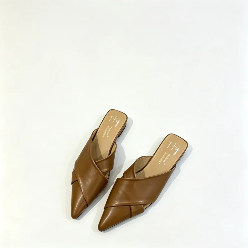Womens mules with pointed toe and flat sole. Leather slip on shoes for everyday wear. French style loafers.