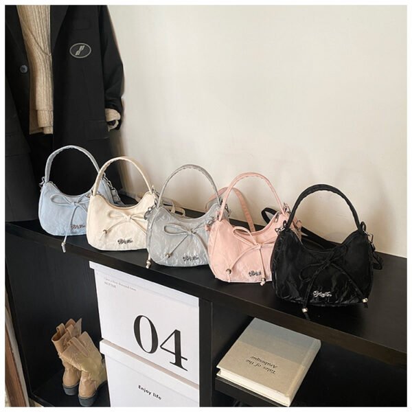 Bow shaped crossbody bag in structured bow silhouette. Cute mini PU leather purse. Fits phone and essentials.