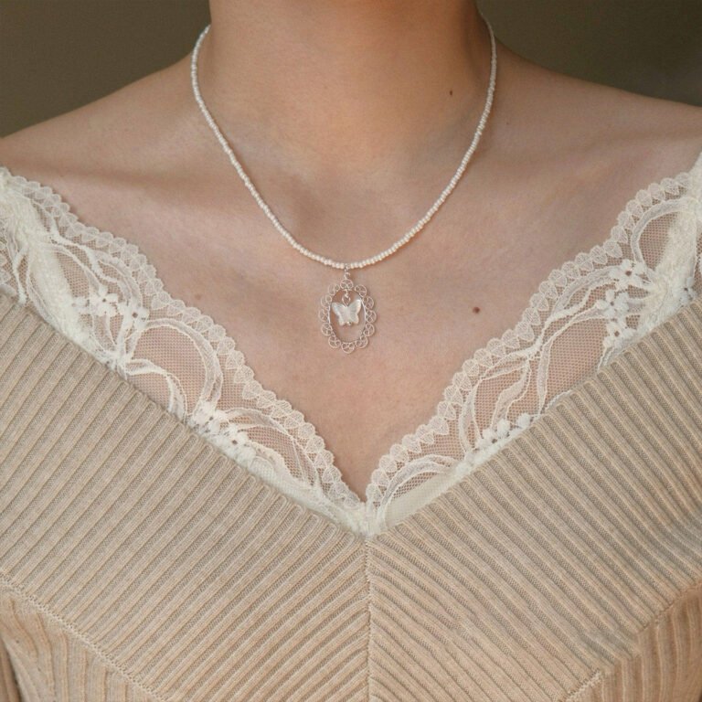 Pearl butterfly necklace with delicate gold chain and tiny pearl accent. Lightweight dainty choker for everyday wear. Adjustable 16-20 inches. Free shipping $38+.
