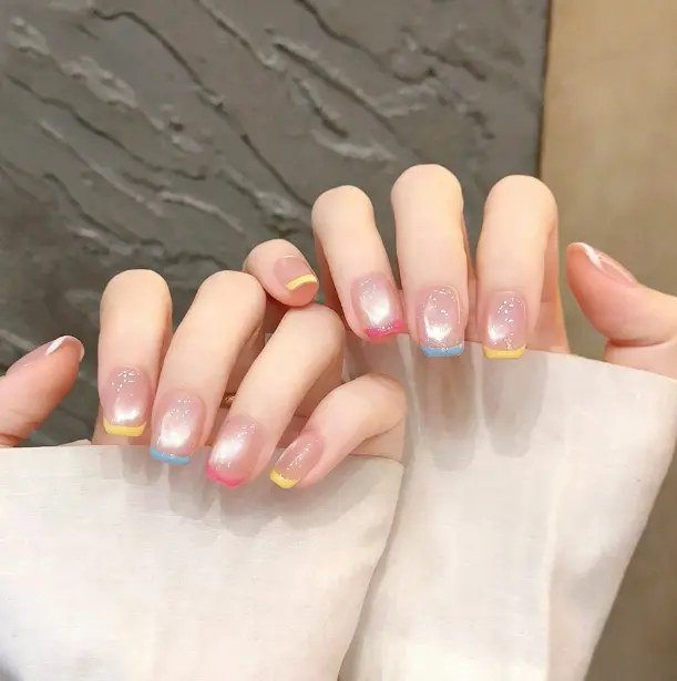 Press on nails with colorful french tip and rainbow cat eye. Pastel shades on each finger. Short length, reusable.