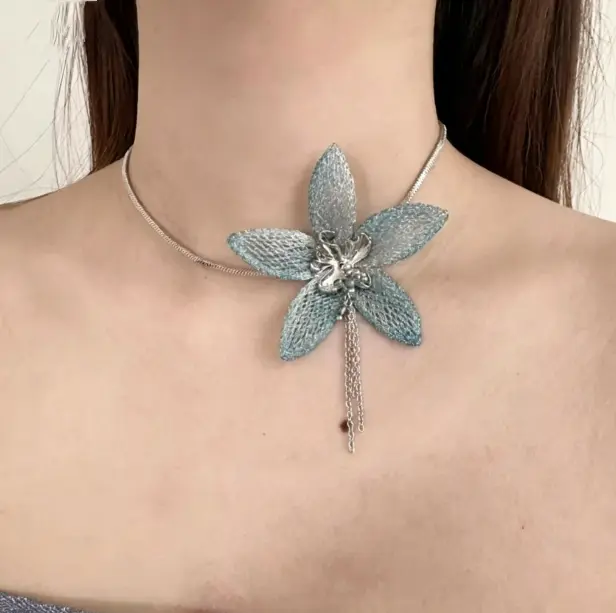 Fabric flower choker with blue petals and tiny tassel. Lightweight boho daisy chain for summer. Adjustable 12-16 inches.