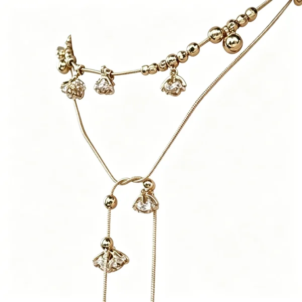 Long flower necklace with lily of the valley crystals. Wear long, double wrap as choker, or triple wrap as bracelet. Gold tone.